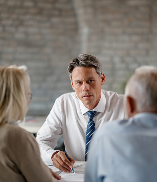 financial advisor senior couple talking while analyzing documents consultations office